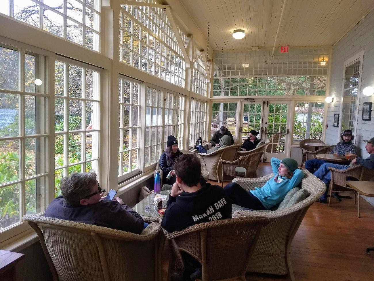People sit in a sunroom in a historic lodge