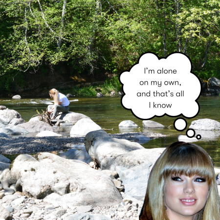 A young woman sits on a river with rocks in the foreground. In the corner a cutout of Taylor Swift has a thought bubble saying, "I'm alone, on my own, and that's all I know."