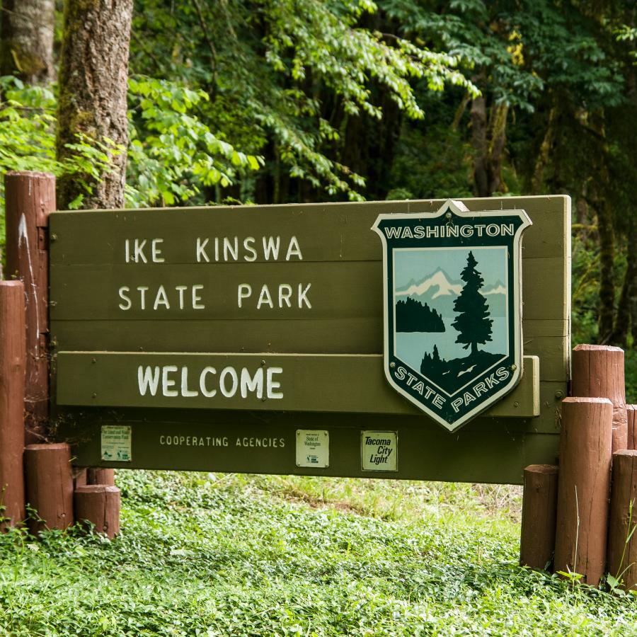 Welcome to Ike Kinswa State Park Sign surrounded by Trees