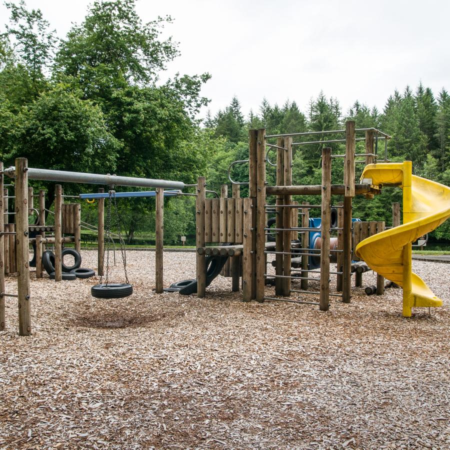 playground with slides, tire swing, and other equipment for children to play on