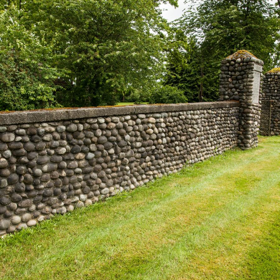 long wall and gateway made entirely of round stones