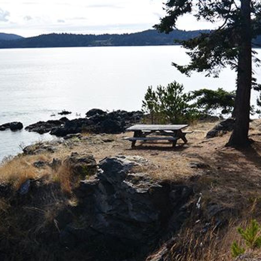 Picnic table near bluff with the ocean and islands in the background