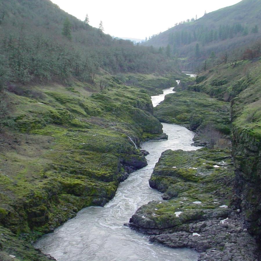 A narrow river runs through a rocky canyon.